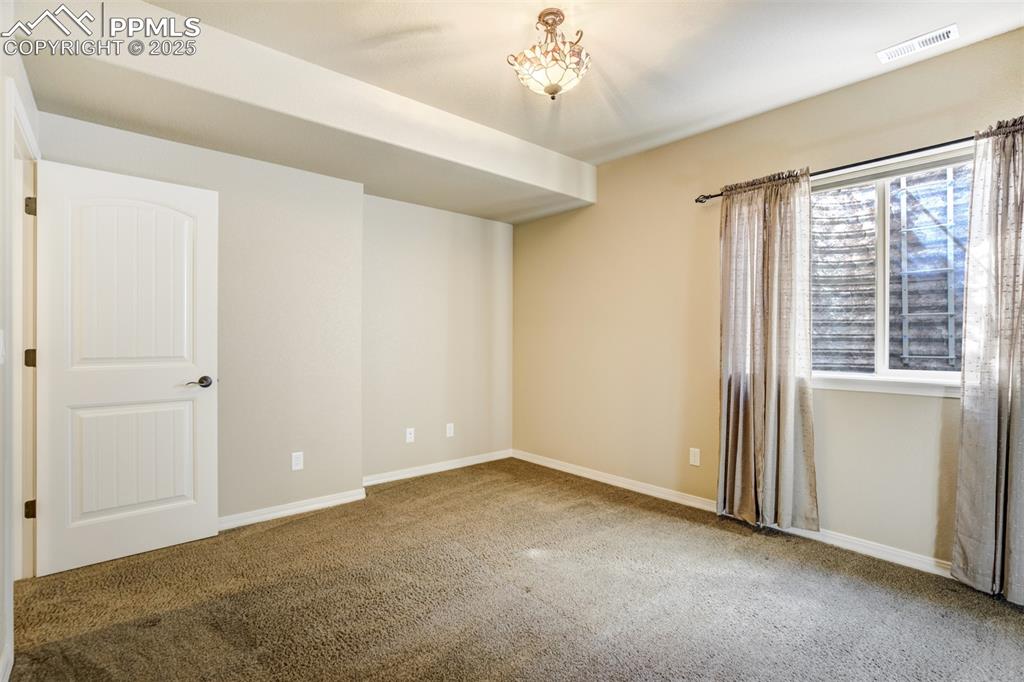 Image 23 of 36: Carpeted empty room with baseboards