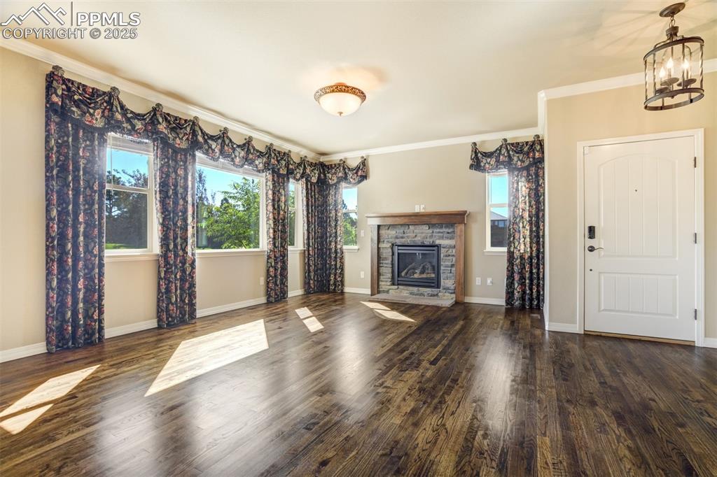 Image 5 of 36: Unfurnished living room featuring a chandelier, plenty of natural light, a 