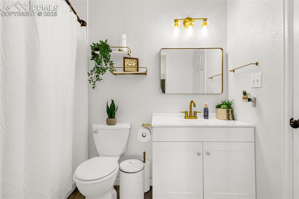 Image 14 of 34: Full bathroom with vanity and a shower with shower curtain