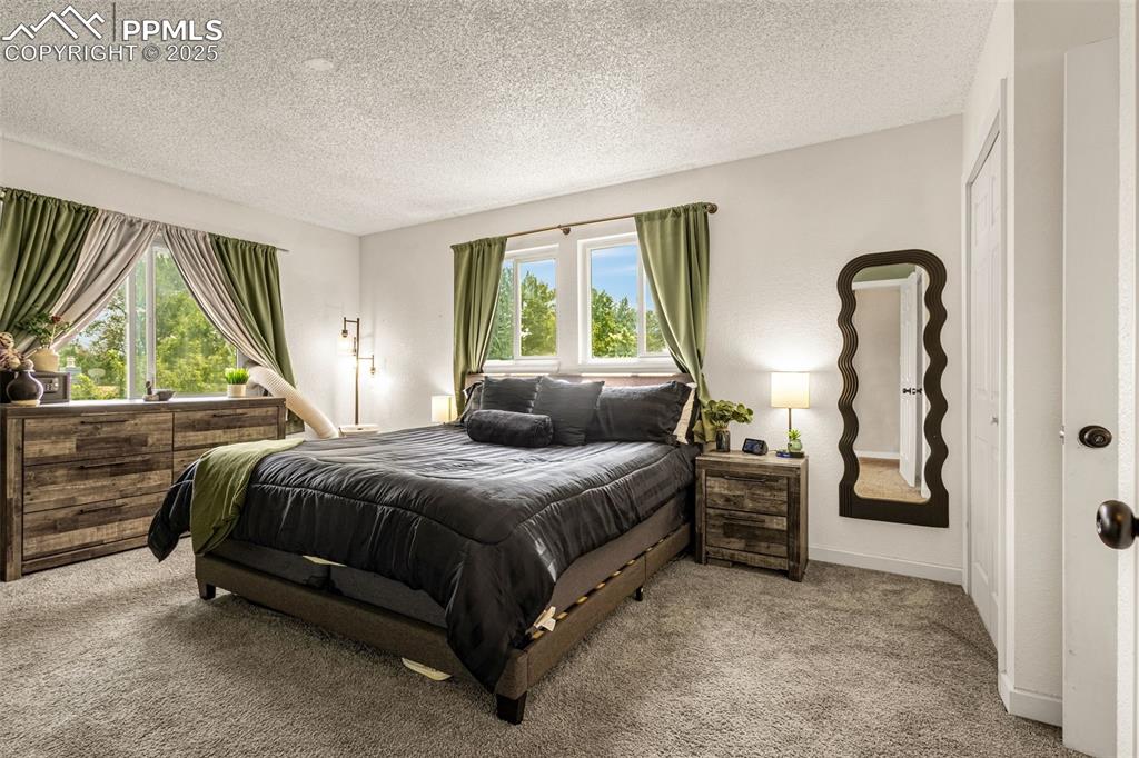 Image 15 of 34: Bedroom featuring carpet flooring and a textured ceiling