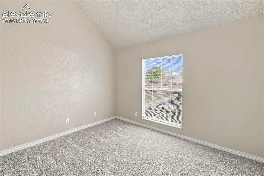 Image 18 of 26: Bright corner bedroom featuring neutral carpeting, fresh painted walls, and