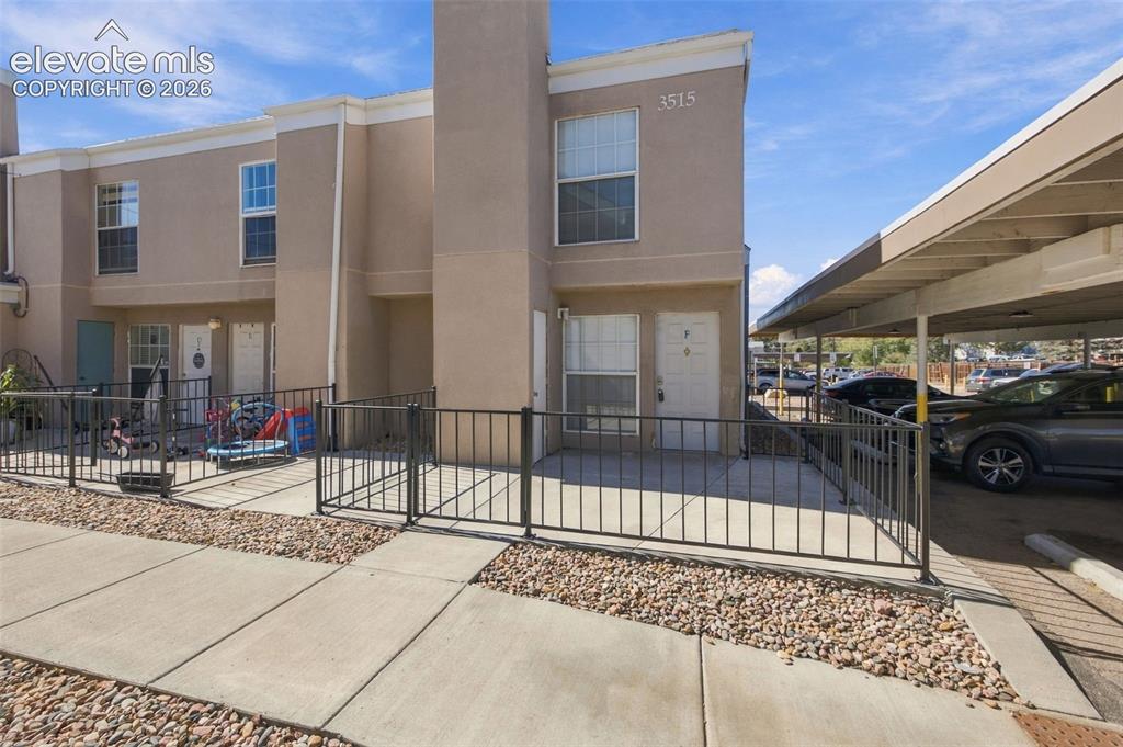 Image 23 of 26: Modern townhome featuring a clean stucco exterior with multi-pane windows,