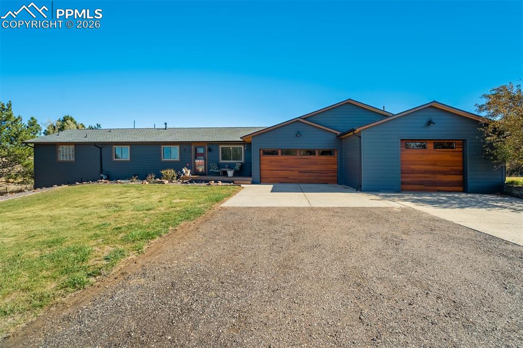 Image 1 of 50: View of front of house with concrete driveway, a garage, and a front lawn