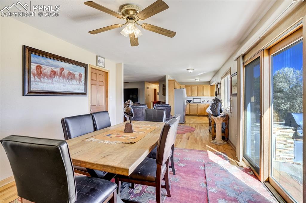 Image 15 of 50: Dining space with light wood-style flooring and a ceiling fan