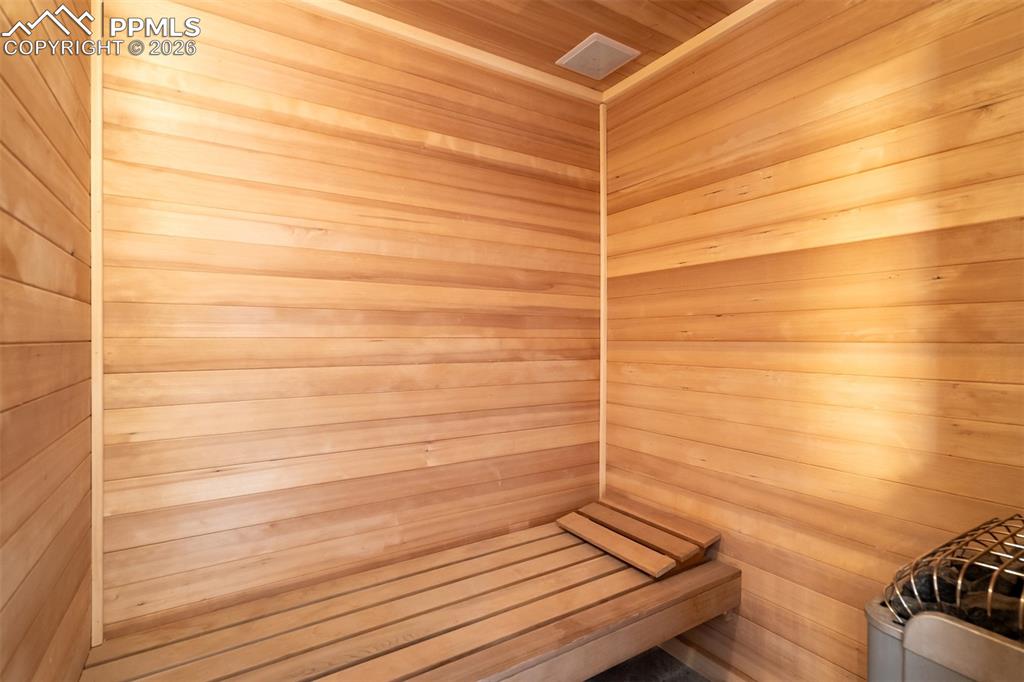 Image 24 of 50: Relaxing sauna featuring wooden walls and wooden ceiling