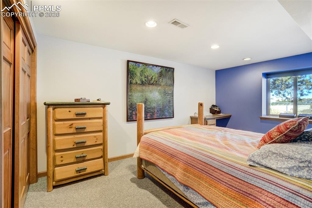 Image 36 of 50: Bedroom with light colored carpet, recessed lighting, and a closet