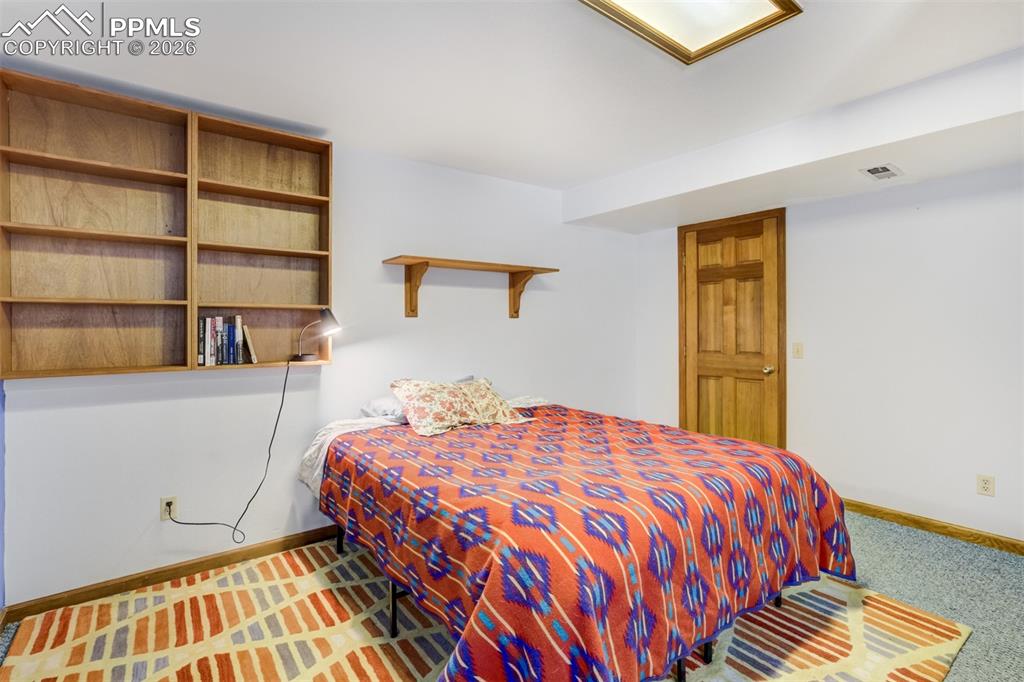 Image 38 of 50: Bedroom featuring baseboards and carpet