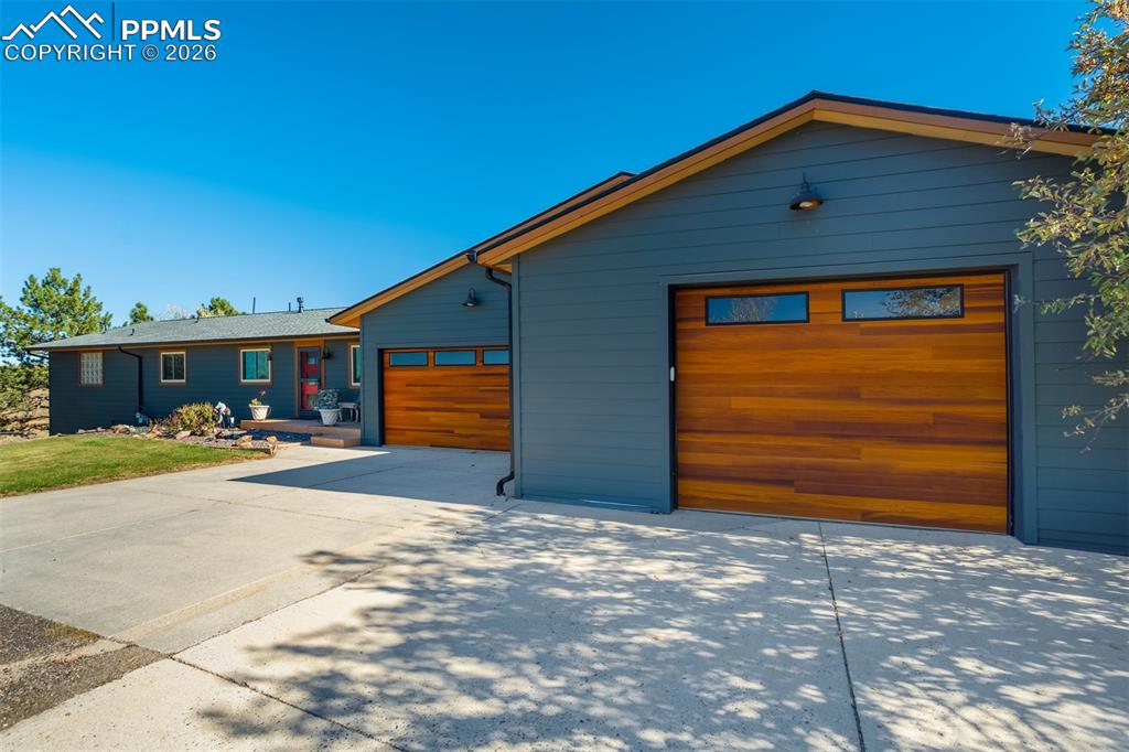 Image 4 of 50: View of front of home with concrete driveway