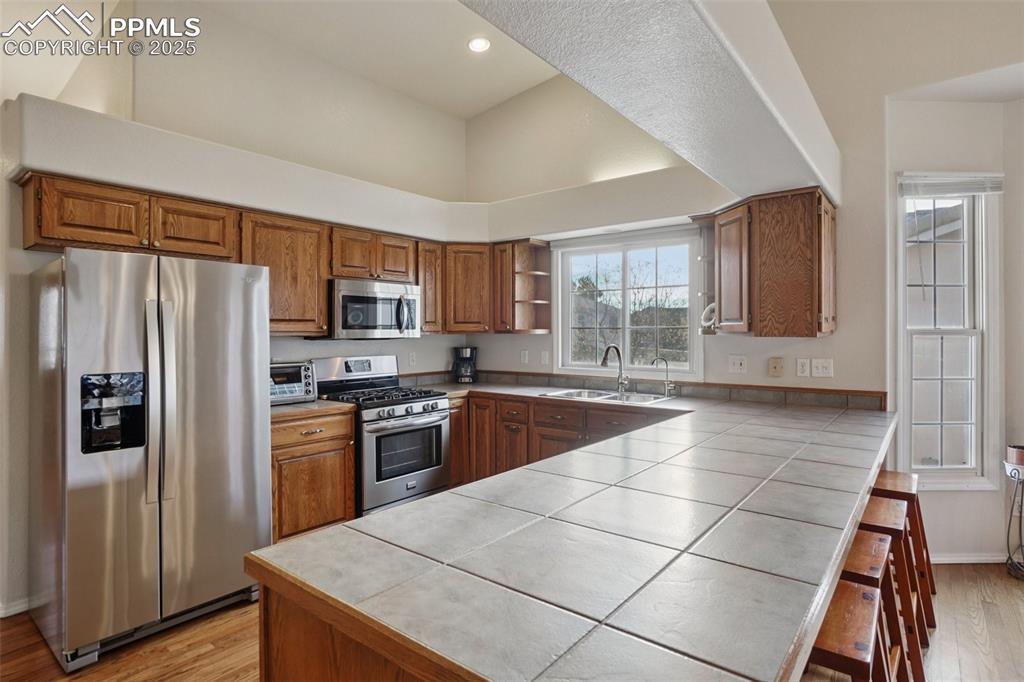 Image 12 of 42: Open kitchen with stainless steel appliances, ample storage space and kitch