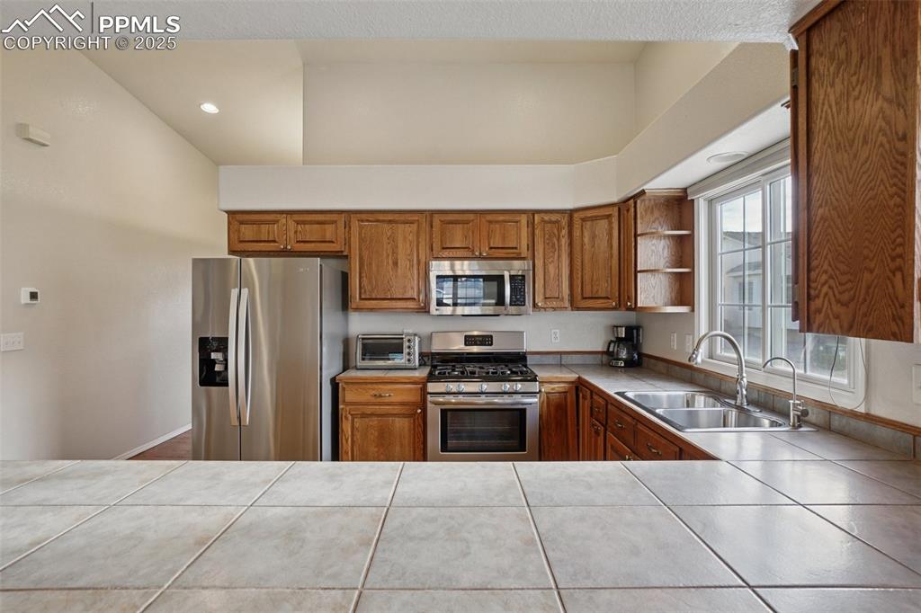 Image 13 of 42: Open kitchen with stainless steel appliances, ample storage space and kitch