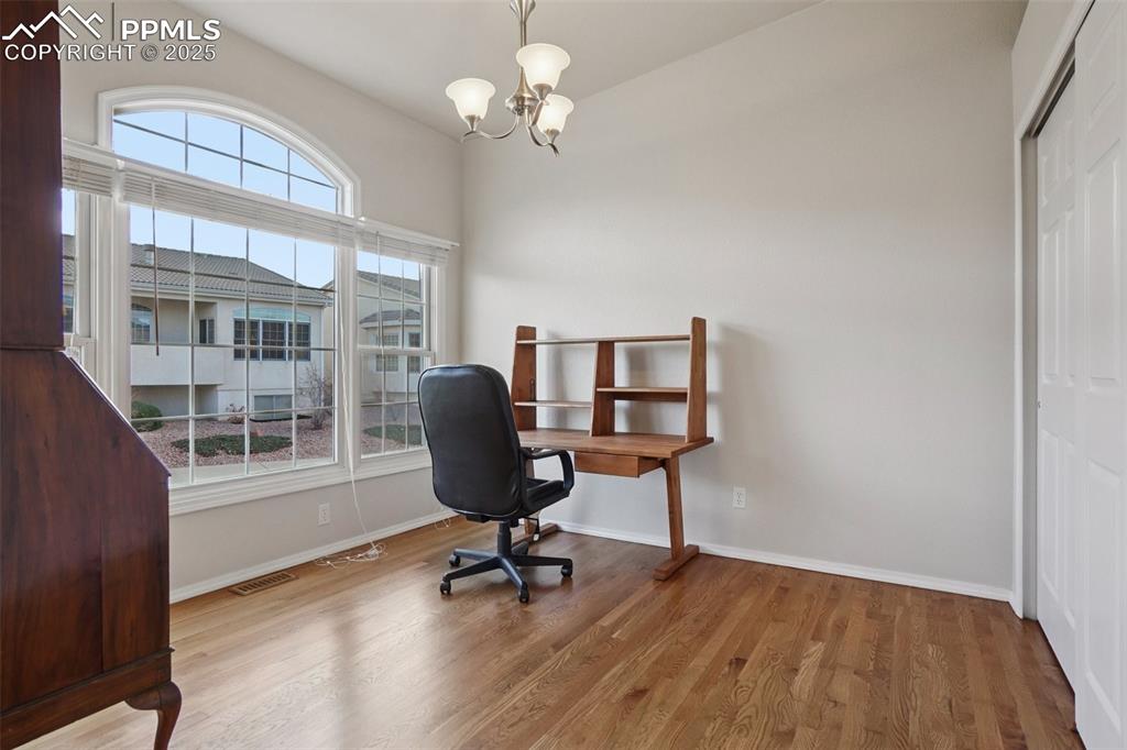 Image 15 of 42: Office space with wood finished floors, french doors and closet.