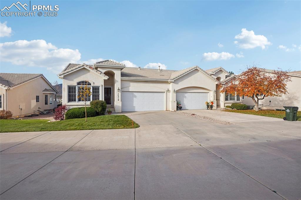 Image 2 of 42: Front of home featuring stately stucco and a tile roof.