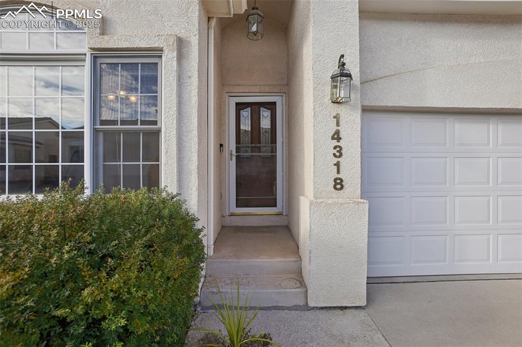 Image 3 of 42: Front of home featuring stately stucco and a tile roof.