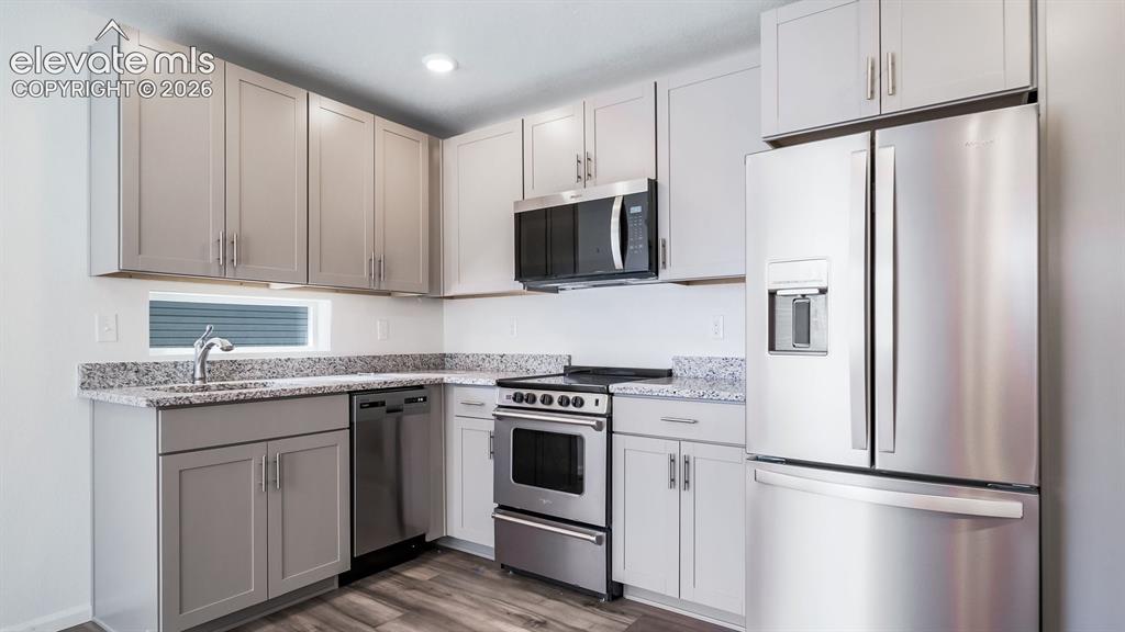 Image 11 of 24: Modern kitchen featuring stainless steel appliances, grey shaker-style cabi