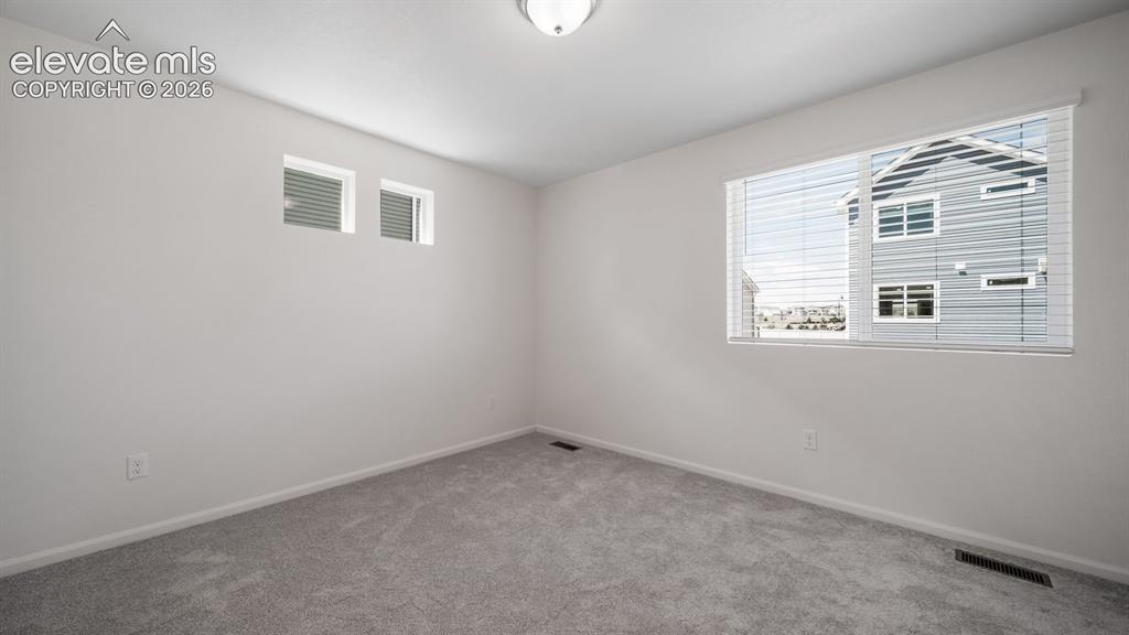 Image 21 of 24: Room featuring light gray carpet, white painted walls, and white baseboards