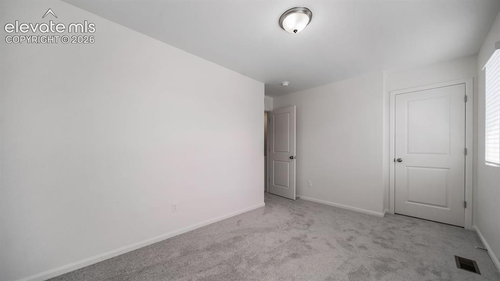 Image 8 of 24: Carpeted room featuring white walls, a flush-mount ceiling light fixture, a