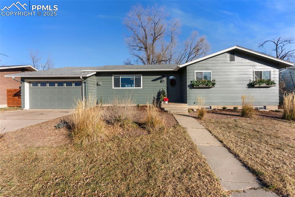 Caption: Ranch-style home with driveway, a garage, and a shingled roof