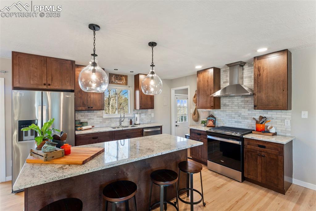 Image 13 of 45: Kitchen featuring light stone countertops, appliances with stainless steel