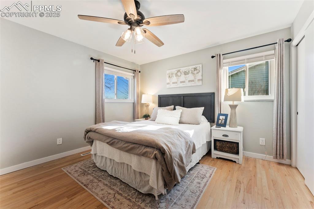 Image 16 of 45: Bedroom with light wood-style floors and a ceiling fan