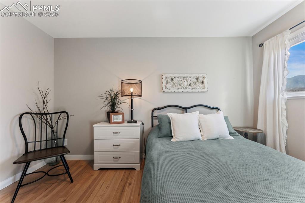 Image 19 of 45: Bedroom with baseboards and light wood-style flooring