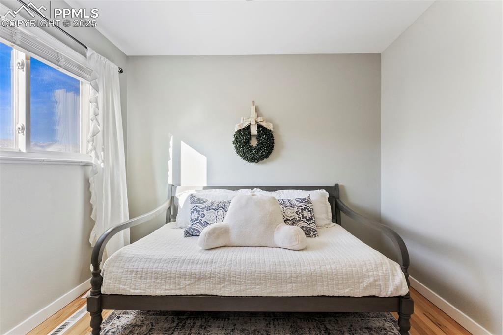 Image 21 of 45: Bedroom with baseboards and light wood-type flooring