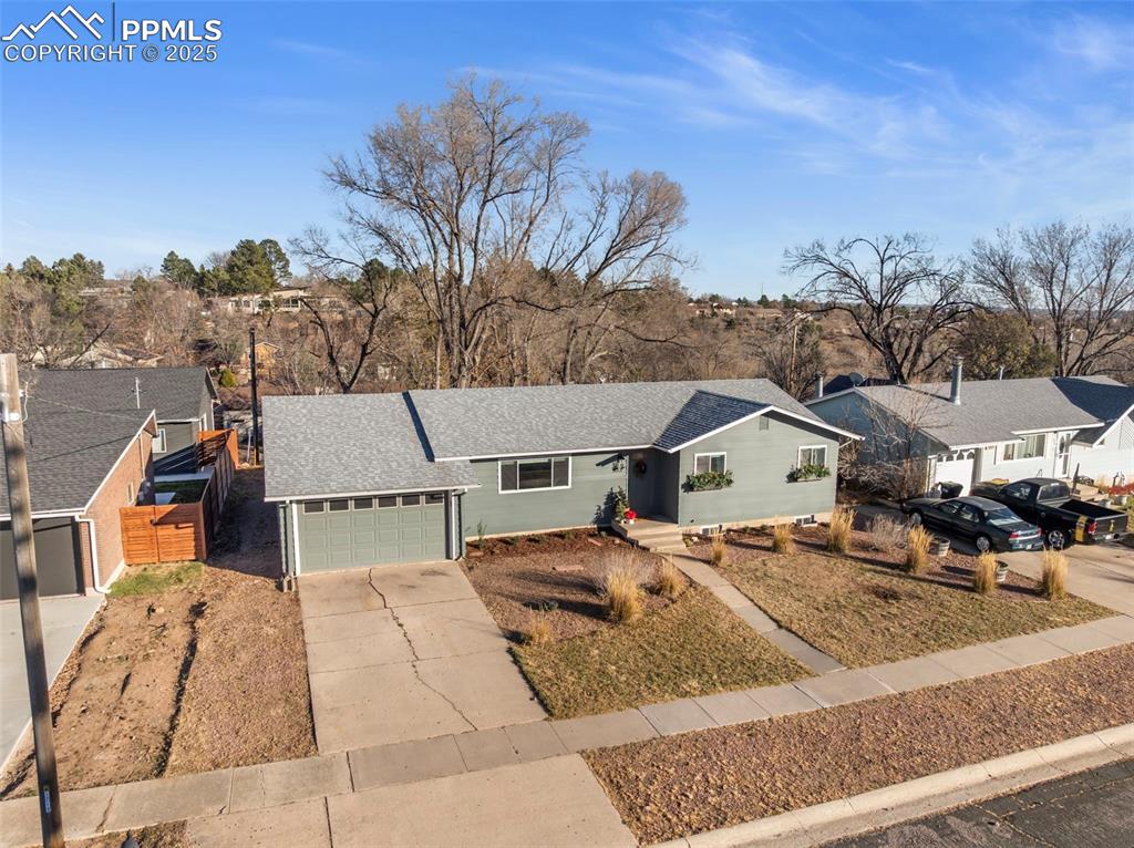 Image 37 of 45: Single story home featuring a shingled roof, driveway, and a garage