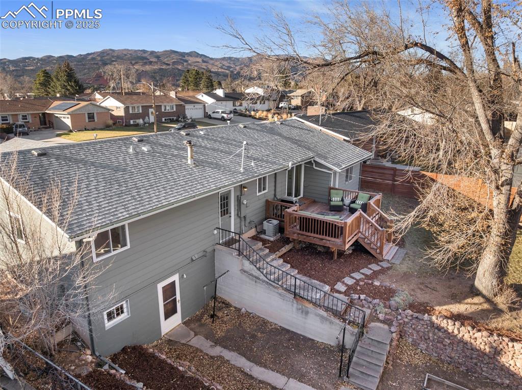 Image 40 of 45: Aerial view of residential area with a mountain backdrop