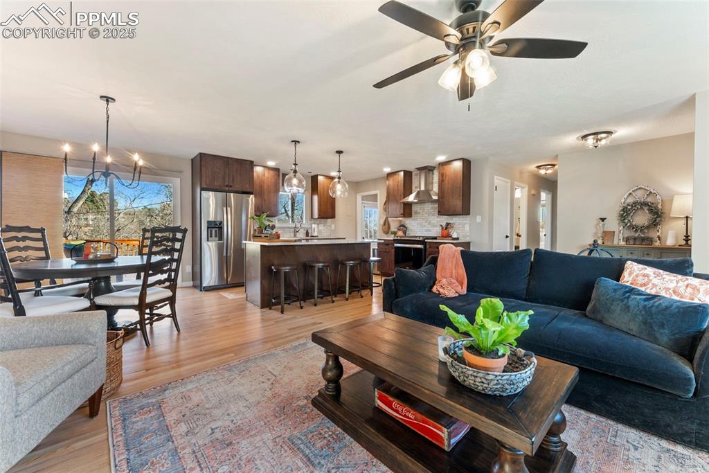 Image 5 of 45: Living area featuring a chandelier, light wood-style floors, recessed light