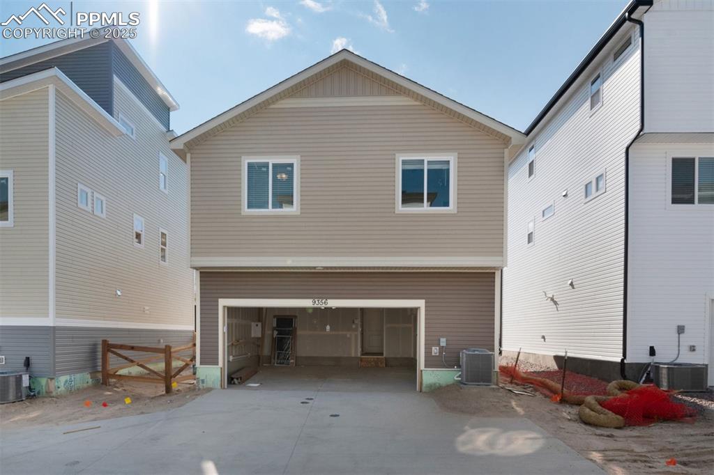 Image 7 of 7: Back of property with driveway and a garage