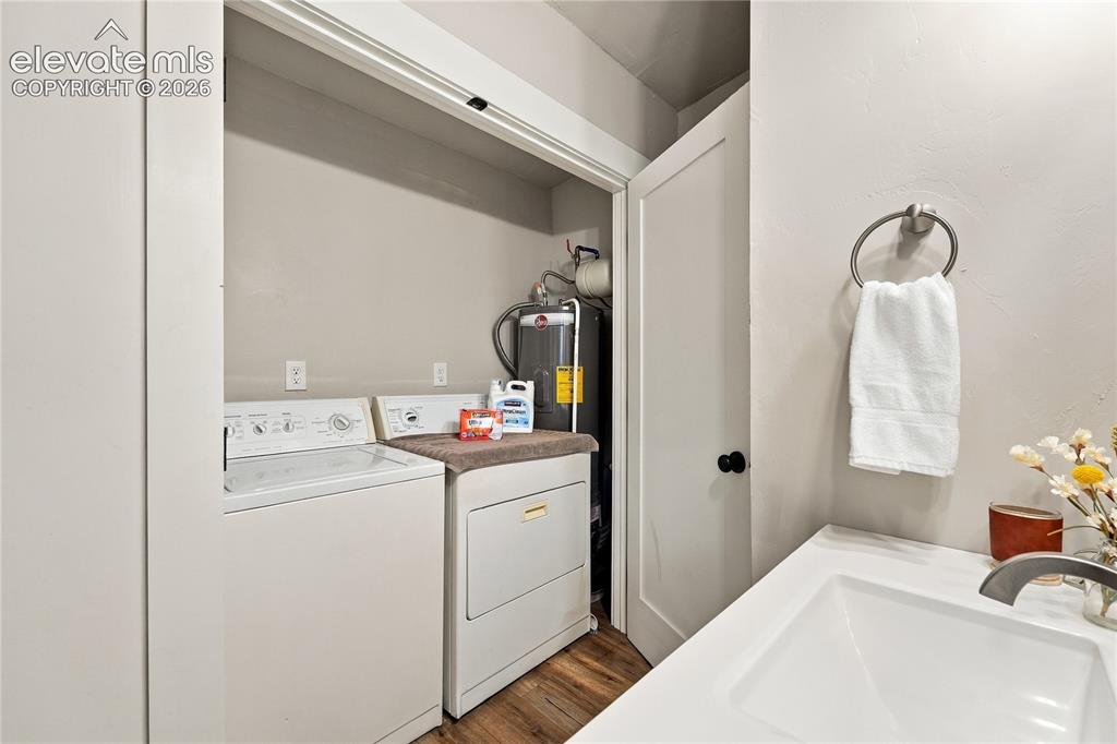 Image 41 of 50: Full bathroom with private laundry area.