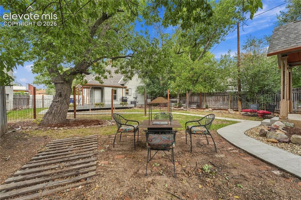 Image 45 of 50: View of yard from Secondary home towards main house.