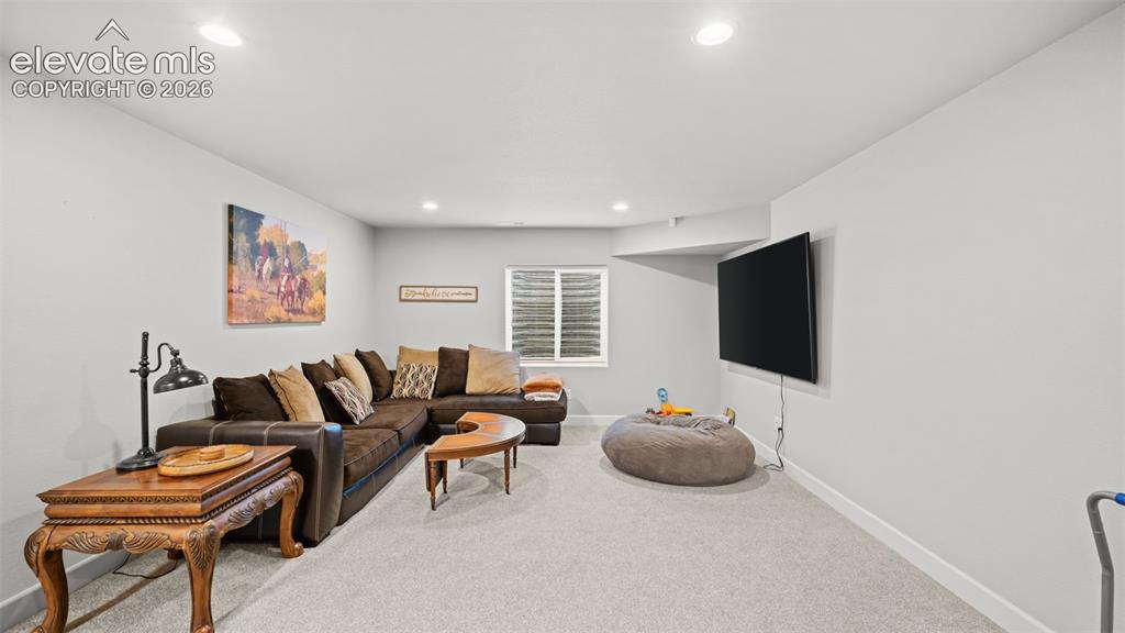 Image 21 of 34: Spacious recreation room featuring recessed lighting, light gray walls, and