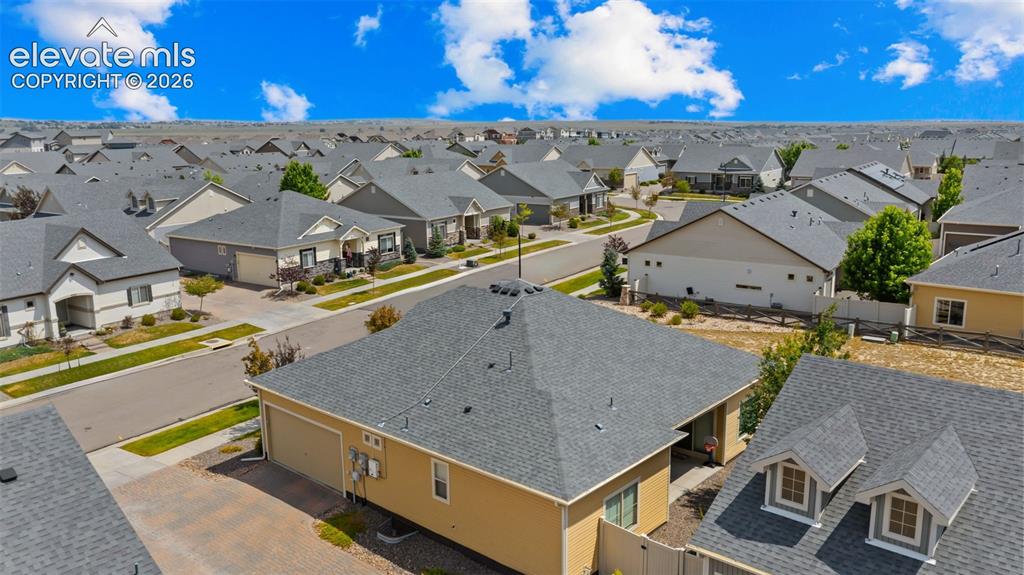 Image 33 of 34: Residential neighborhood featuring single-story homes with dark grey shingl