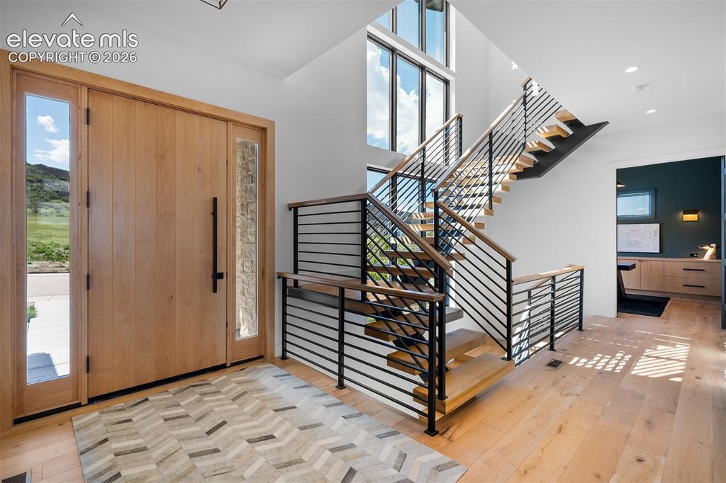 Image 13 of 38: Floating open-riser staircase introducing architectural dimension.