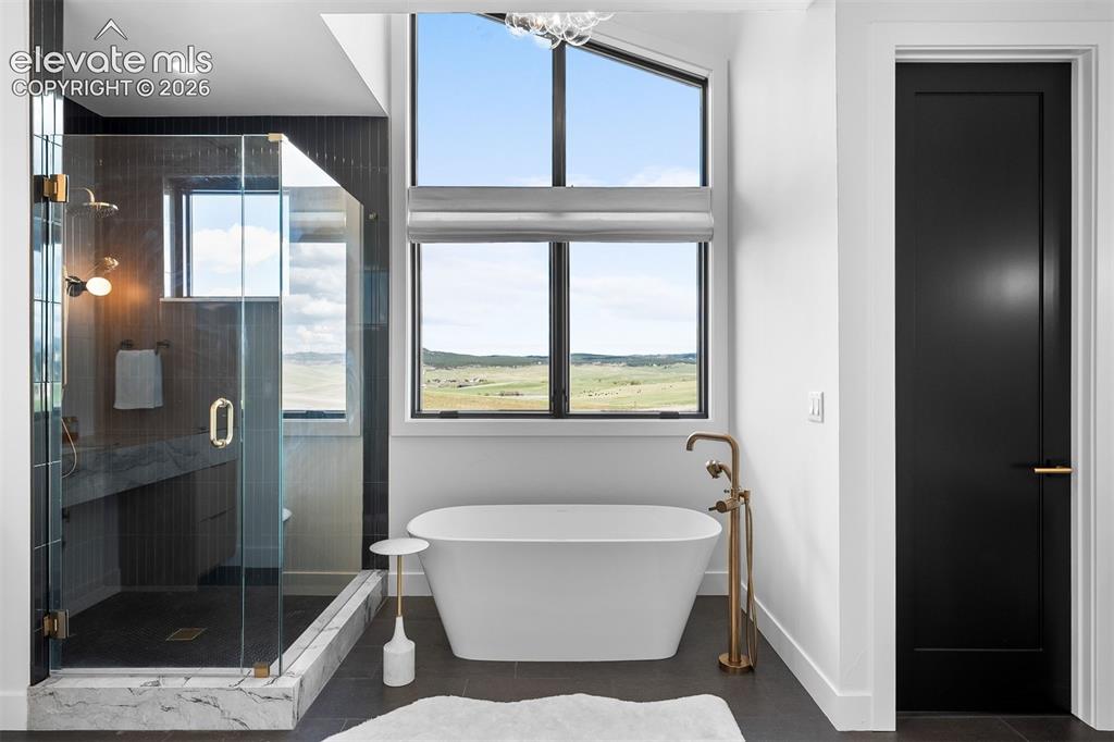 Image 19 of 38: Upper-level landing surrounded by expansive windows and modern railing deta