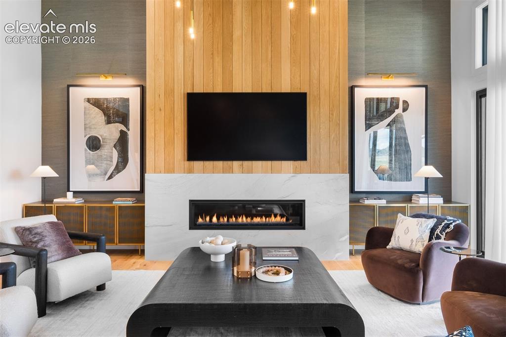 Image 3 of 38: White oak and marble fireplace surround creating a refined focal point.