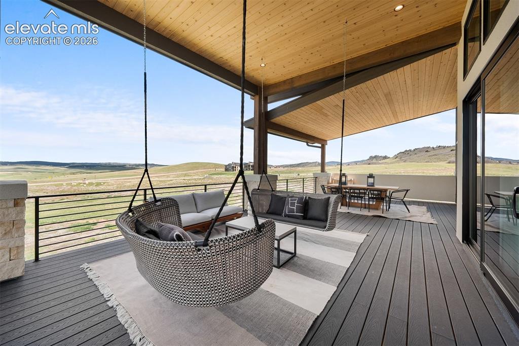 Image 35 of 38: Full-length covered deck designed for seamless indoor-outdoor living.