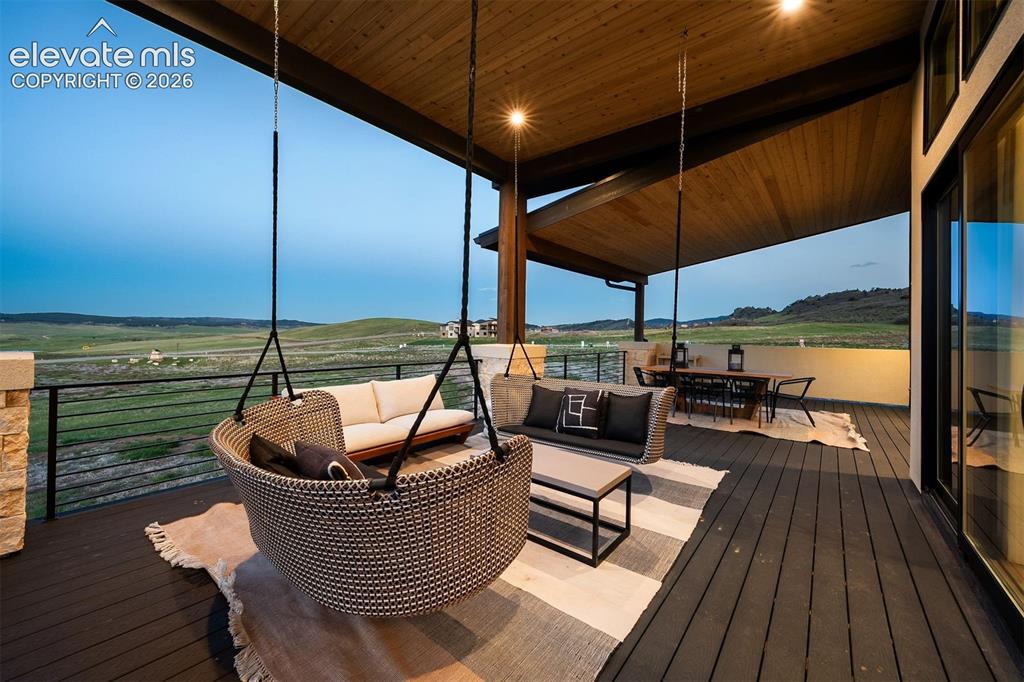 Image 8 of 38: Rear elevation showcasing covered outdoor living and walkout design.