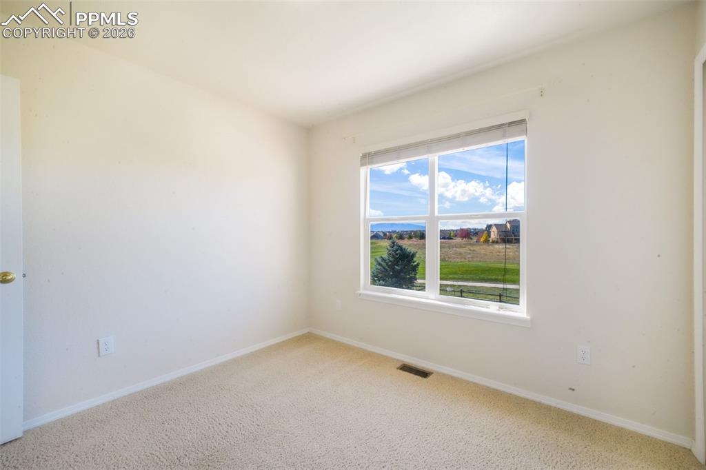 Image 33 of 50: Carpeted spare room with baseboards