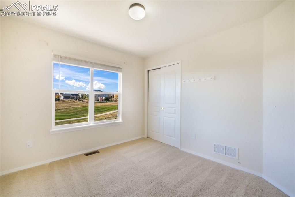 Image 34 of 50: Spare room with light carpet and baseboards