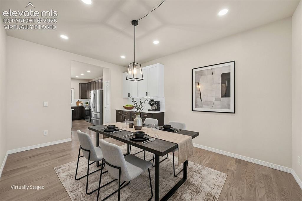 Image 12 of 48: Dining Room with additional cabinetry. Virtually Staged.
