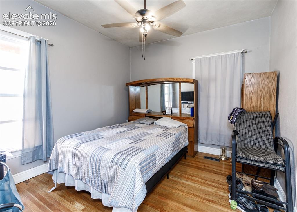 Image 11 of 25: Hardwood flooring, painted walls, ceiling fan with integrated lighting, and