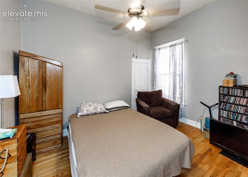 Image 14 of 25: Hardwood-style flooring throughout with a ceiling fan light fixture and a w