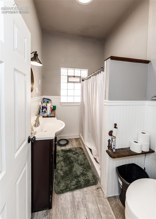 Image 16 of 25: Bathroom featuring a dark wood finish vanity with a white basin sink, wood-