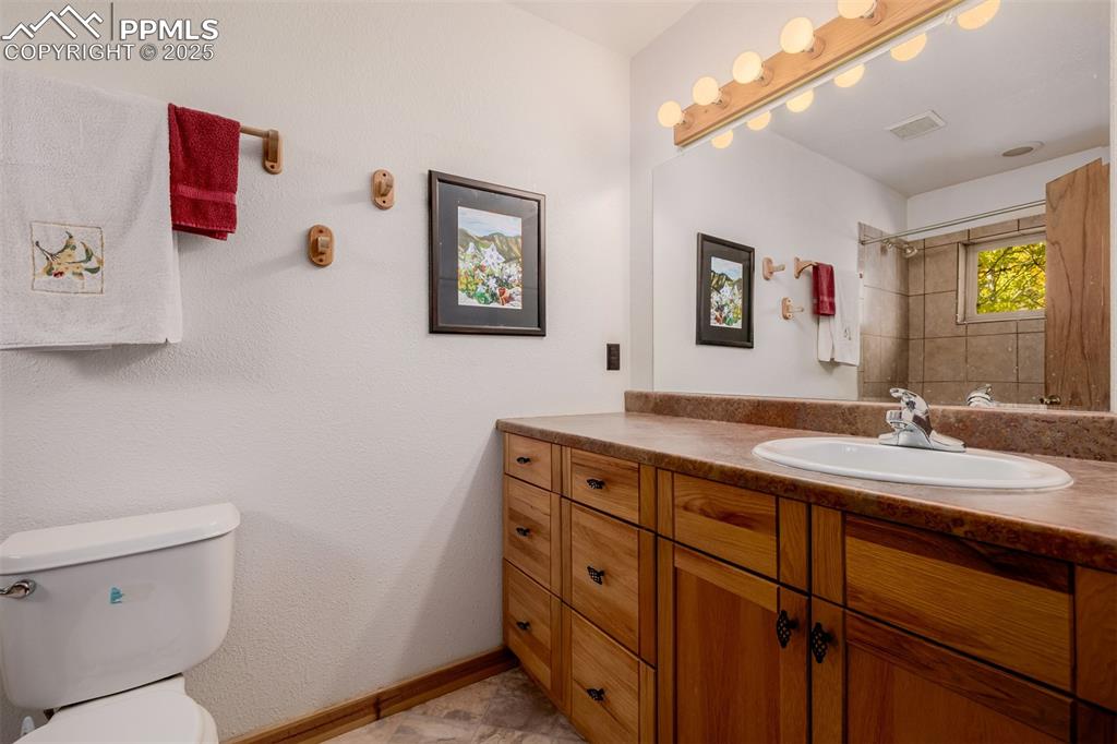 Image 20 of 48: Full bath with vanity and a tile shower