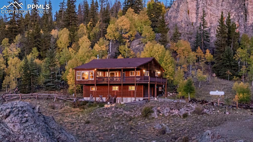 Image 3 of 48: Back of house featuring a forest view