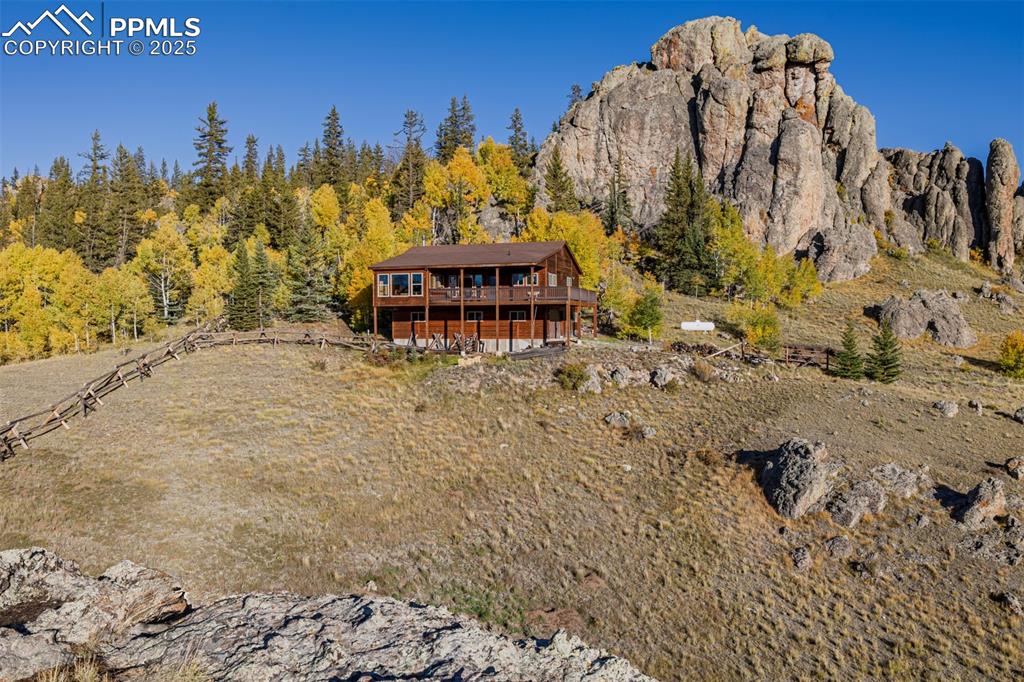 Image 35 of 48: View of mountain background with a heavily wooded area