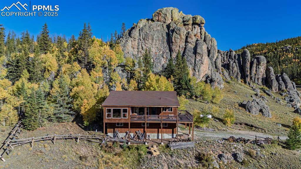 Image 37 of 48: View of mountain background featuring a heavily wooded area