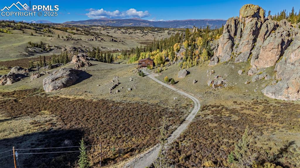 Image 43 of 48: Aerial view of property and surrounding area with mountains