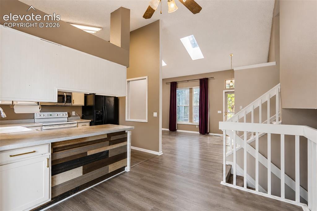 Image 14 of 35: View of Dining Room, Kitchen, and Living Room.